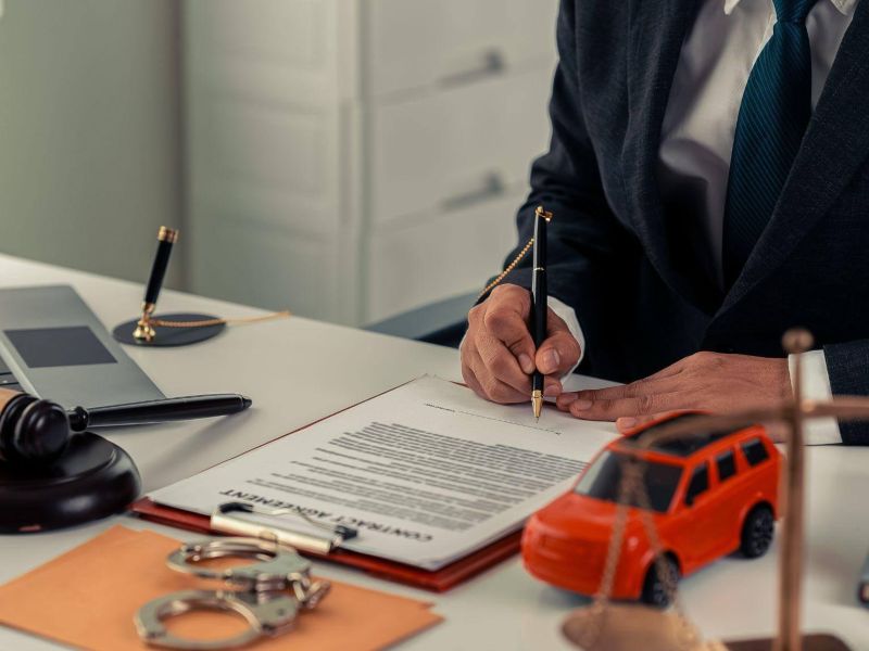 a man sitting at a desk signing a document