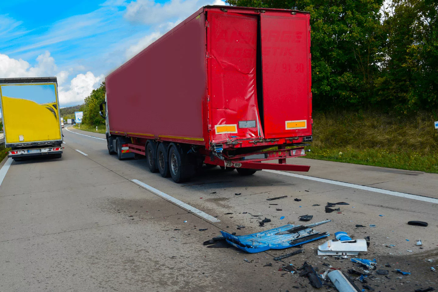 debris behind a damaged semi truck after accident