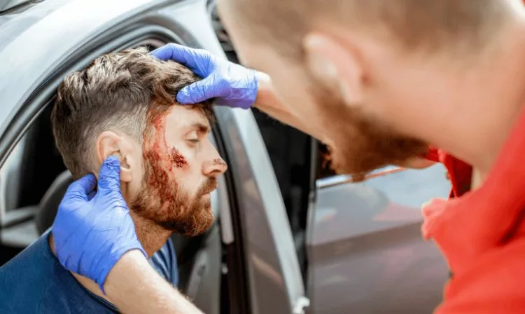Male who sustained head injury in car accident is cared for