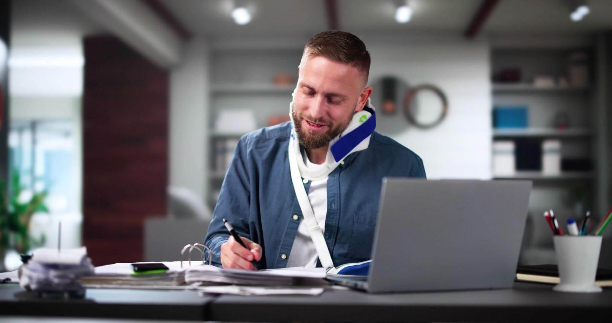 a man sitting in front of a laptop computer